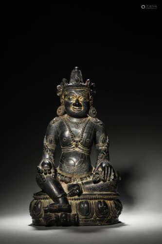 A Tibetan stone yellow Jambhala statue