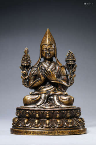 A Copper and Silver Inlaid Guru Statue