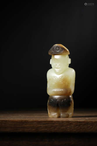 A WHITE AND RUSSET JADE FIGURE OF HUMAN