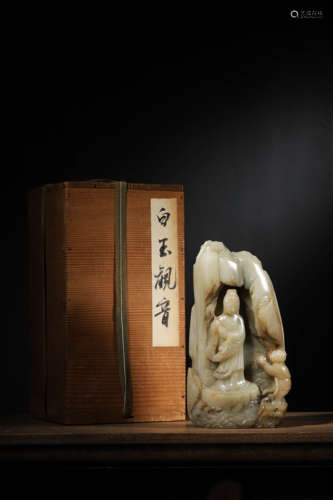 A CARVED RUSSET AND WHITE JADE BOULDER