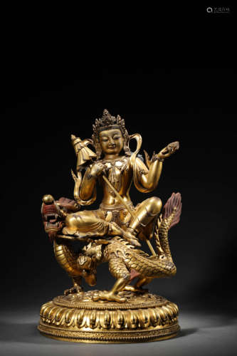 A Tibetan Gilt-Bronze Buddhist Guardian On Dragon