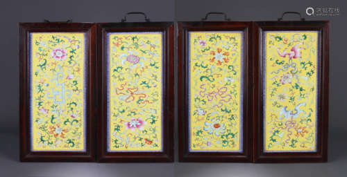 A SET OF FOUR YELLOW-GROUND YANGCAI FLOWER AND ANTIQUE PANEL...