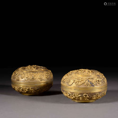 A PAIR OF GOLD FIGURE STORY BOXES AND COVERS