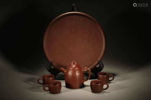 A SET OF PURPLE CLAY LOBED TEAPOT AND CUPS