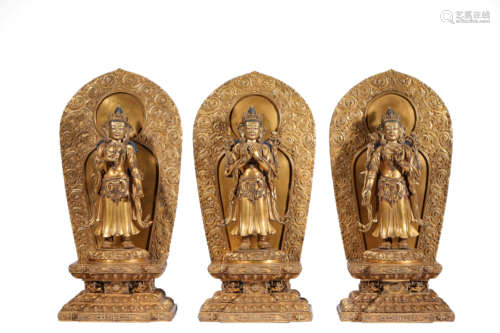 A SET OF THREE GILT-BRONZE STATUES OF BUDDHA