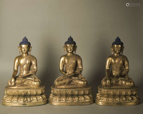 A GILT-BRONZE BUDDHIST TRIAD