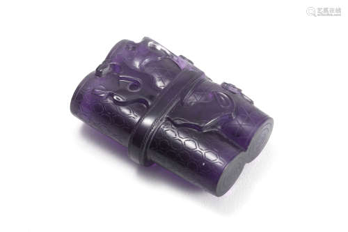 A PURPLE CRYSTAL PAPER WEIGHT