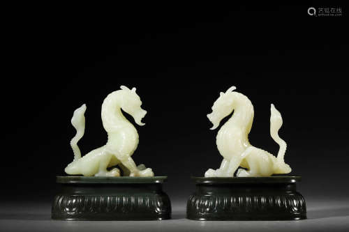 A PAIR OF WHITE JADE DRAGONS WITH CELADON JADE BASES