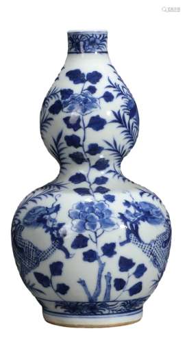 A BLUE AND WHITE DRAGON AND FLOWER DOUBLE-GOURD VASE