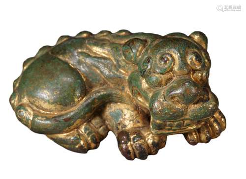 A GILT COPPER MYTHICAL BEAST PAPER WEIGHT