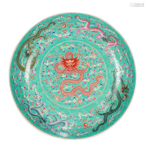 A LARGE GREEN GROUND FAMILLE ROSE FIVE DRAGONS PLATE