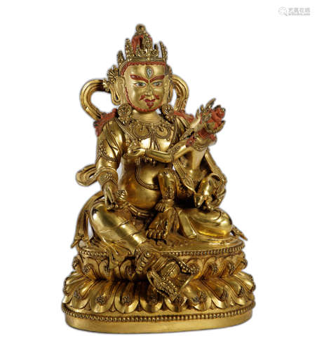 A GILT-COPPER FIGURE OF JAMBHALA