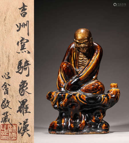 A JIZHOU PORCELAIN STATUE OF ARHAT