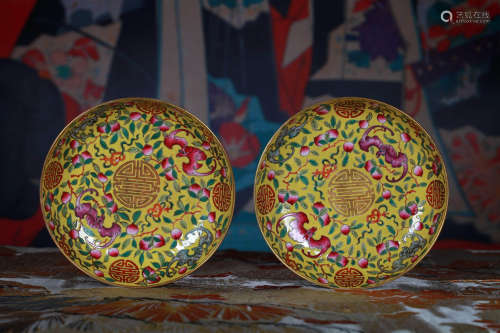 A PAIR OF YELLOW GROUND FAMILLE ROSE BAT AND SHOU DISHES