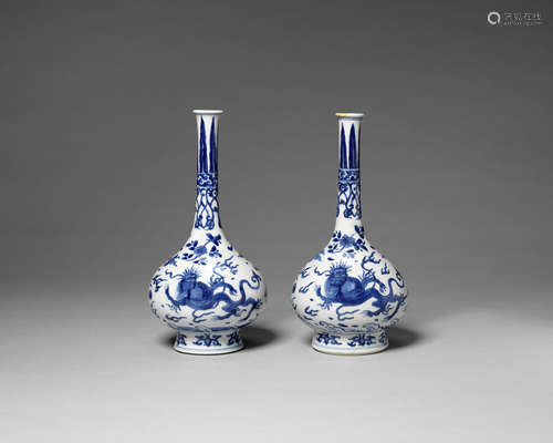 A near pair of blue and white bottle vases.  Kangxi