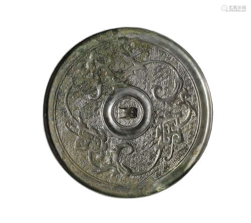 A circular bronze mirror.  Warring States Period