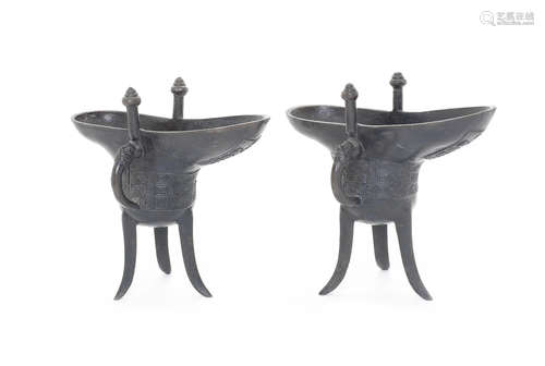 Two bronze tripod wine vessels, jue.  Dated Qianlong 3rd year (1738) and of the period