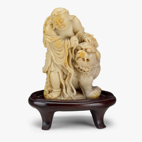 A fine Chinese soapstone carving of a luohan and mythical beast, 18th century