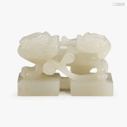 A Chinese white jade unincised double-seal with two chilong to finial,