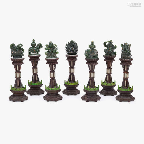 A set of seven Chinese white jade-inset wooden altar pieces, mounted with spinach jade carvings of the Buddhist Seven Emblems of Roy...