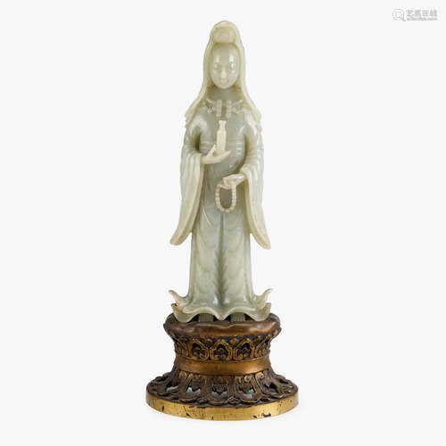 A Chinese celadon jade figure of Guanyin holding a necklace and a sacred vase, 19th/20th century