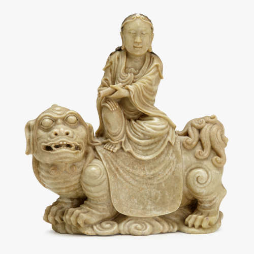 A fine Chinese soapstone carving of a luohan seated over a qilin, 17th/18th century
