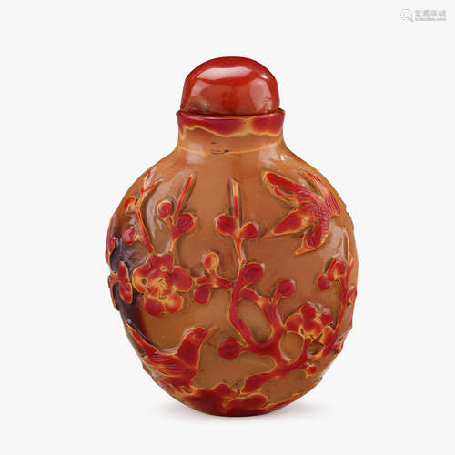 A Chinese realgar glass snuff bottle, carved with birds and flowering foliage, qing dynasty