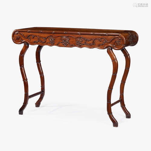 A Chinese hardwood altar table with carved aprons and curved bamboo-stem legs, 19th century