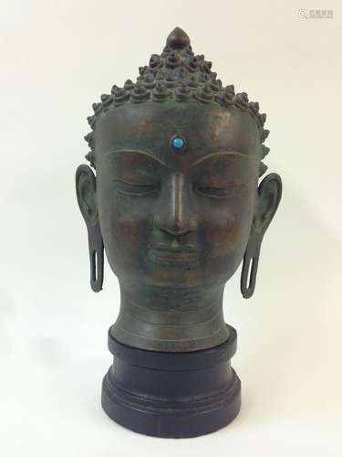 A large Tibetan cast bronze head of Buddha Shakyamuni, early 20th century