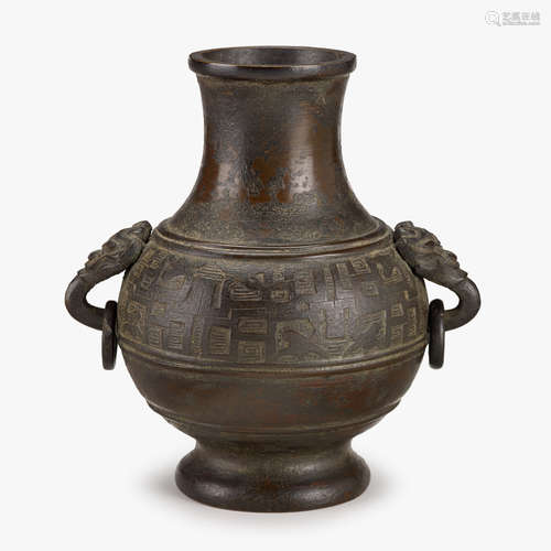 A Chinese cast bronze 'Hu' bottle vase with lion mask ring handles, ming dynasty