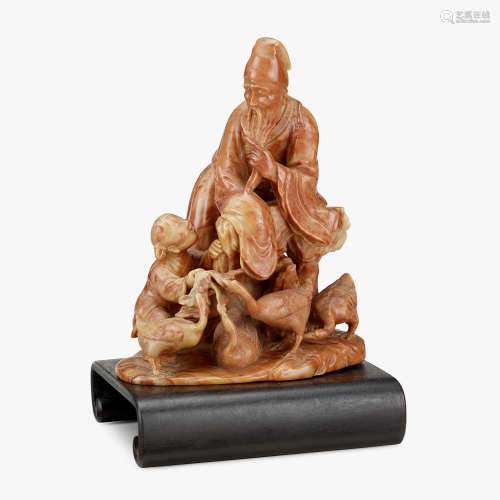 A Chinese soapstone carving of an elderly scholar with child and geese, 19th century