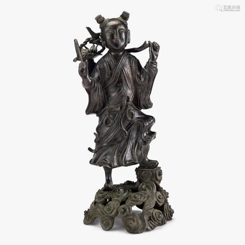 A Chinese cast bronze figure of an acolyte carrying a peach basket, early qing dynasty