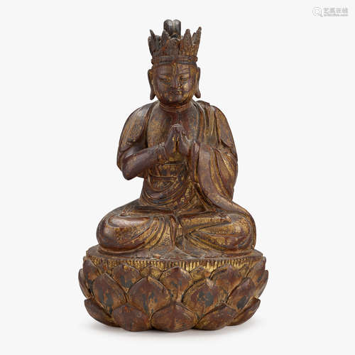 A Chinese gilt-lacquered wood figure of Vairocana seated on a lotus base, ming dynasty