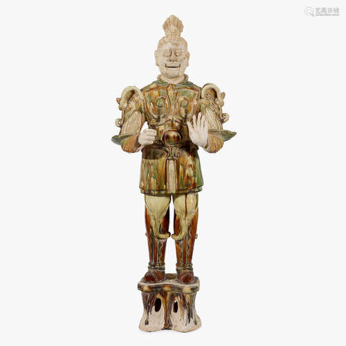 A Chinese sancai glazed pottery tomb guardian figure, tang dynasty