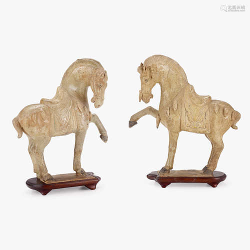 A pair of Chinese glazed pottery prancing horses, with caparison and tassled chest-strap and crouper, tang dynasty