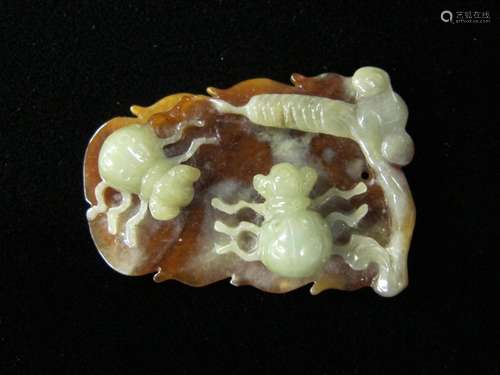 A Chinese green and brown jade pendant carved with insects, 20th century