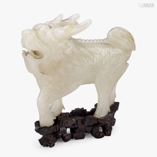 A Chinese white jade poised qilin, 19th century