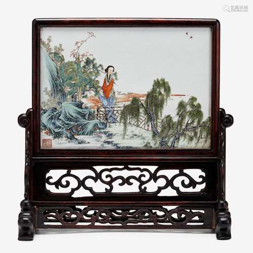 A Chinese famille rose enalemed porcelain plaque depicting a lady in a garden, qianlong mark, late qing dynasty