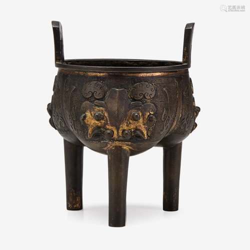 A Chinese archaistic gilt-bronze tripod censer with taotie mask decorations to body, chen da sheng zao mark to base, qing dynasty