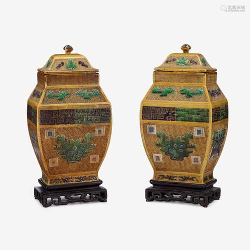 A pair of Chinese sancai glazed porcelain covered urns, six-character raised xuande mark, 18th century