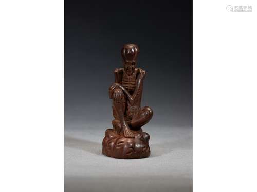 AN AGARWOOD CARVED FIGURE OF LUOHAN