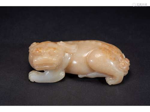 A WHITE AND RUSSET JADE CARVING OF QILIN