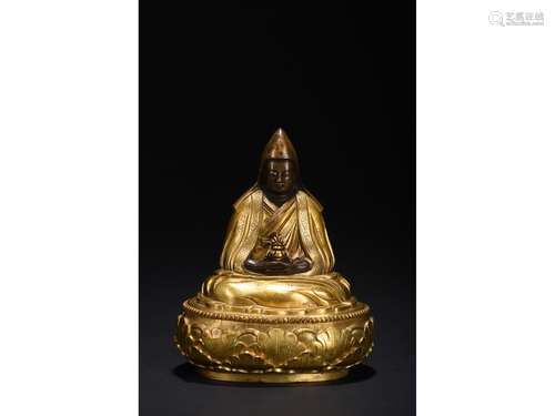 A GILT-BRONZE FIGURE OF GURU