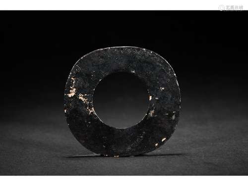 A DARK OPAQUE JADE CARVED DISC