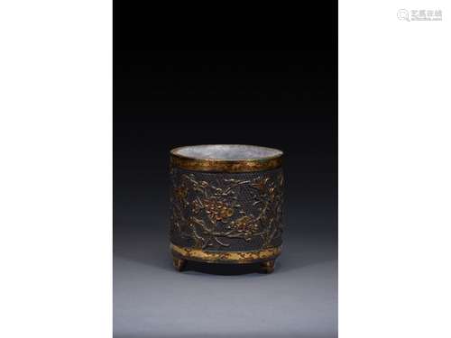 A PARCEL GILT BRONZE 'PLUM BLOSSOM' TRIPOD CENSER