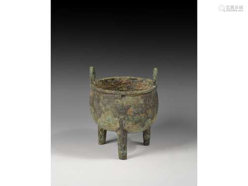 AN ARCHAIC BRONZE TRIPOD VESSEL