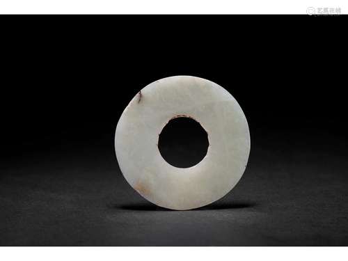 AN ARCHAISTIC WHITE JADE CARVED DISC