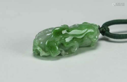 A Translucent Green Jadeite Carved ‘Buddha’s Hand and Chi Lung’ Pendant