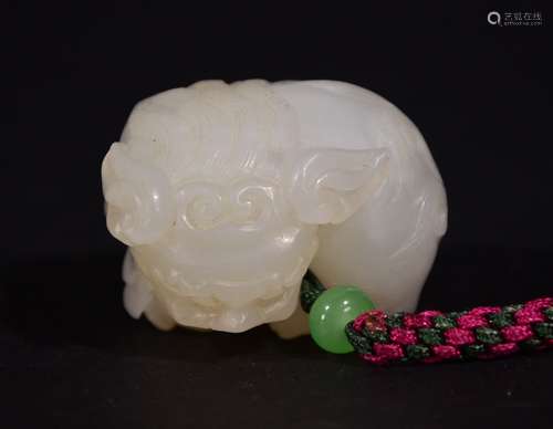 A CARVED HETIAN JADE PENDANT OF LION