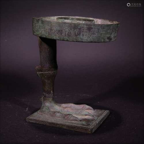 HAN D., A CARVED BRONZE CANDLESTICK